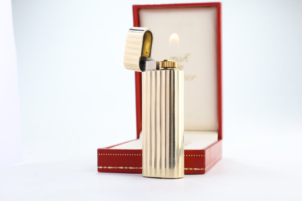 Cartier Le Must lighter with a solid 18k gold jacket and godron ribbing, in its original red Cartier box