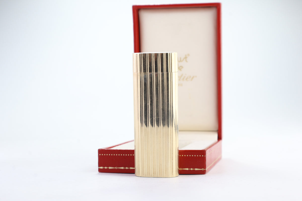 Cartier Le Must lighter with a solid 18k gold jacket and godron ribbing, in its original red Cartier box