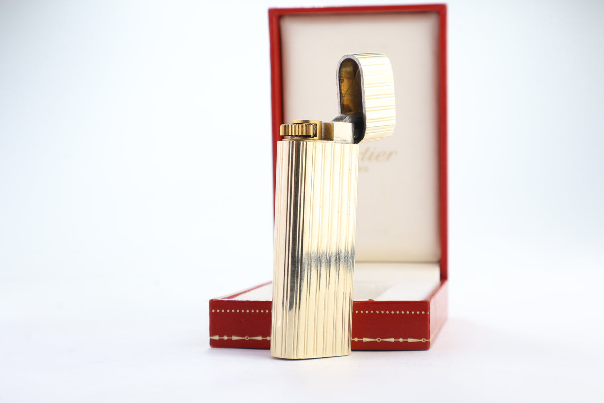 Cartier Le Must lighter with a solid 18k gold jacket and godron ribbing, in its original red Cartier box