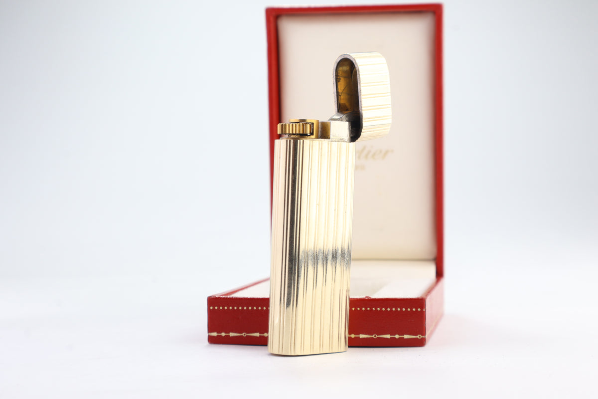 Cartier Le Must lighter with a solid 18k gold jacket and godron ribbing, in its original red Cartier box