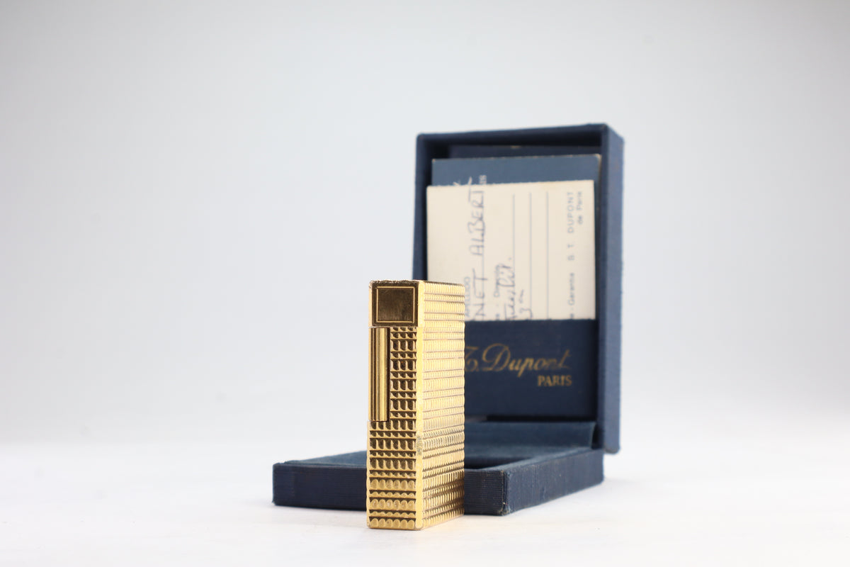 S.T. Dupont Ligne 1 BR large gold lighter with a squared quadrillage pattern, with its navy box and guarantee card