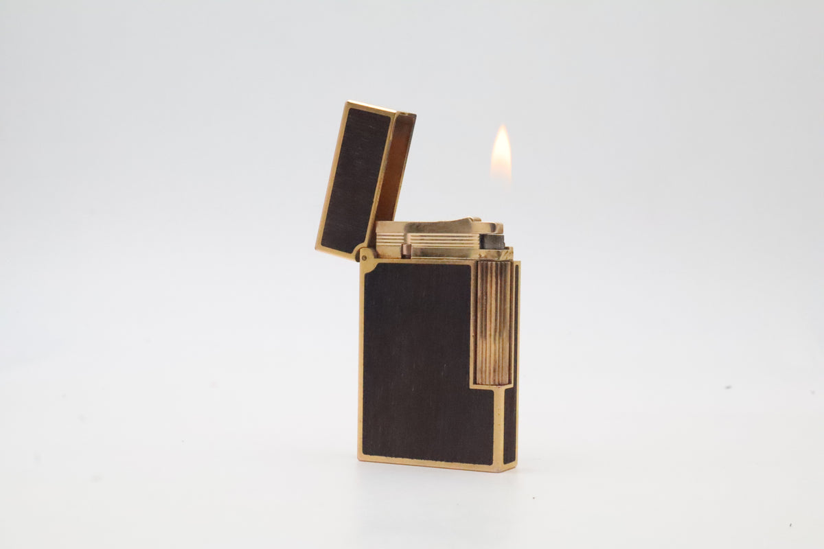 S.T. Dupont Ligne 2 gold plated lighter with dark wood inlay panels, marked MODELE on the base
