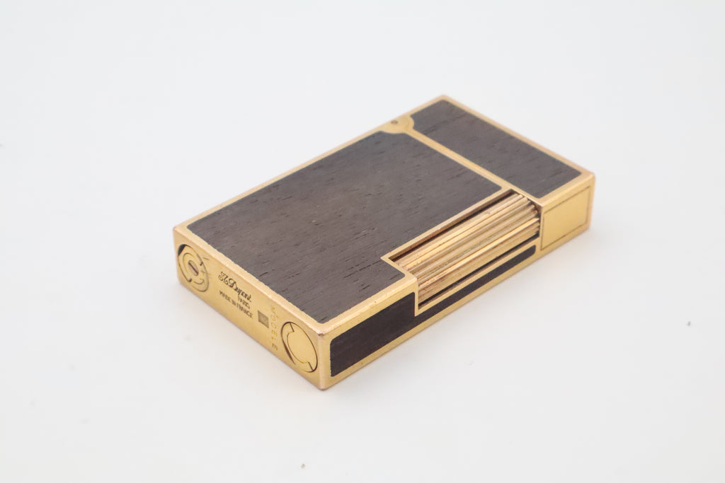 Base of the S.T. Dupont Ligne 2 wood inlay lighter, engraved S.T. Dupont Paris Made in France and marked MODELE in place of a serial number
