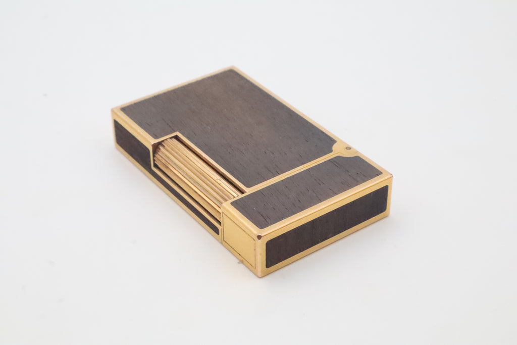 S.T. Dupont Ligne 2 gold plated lighter with dark wood inlay panels, marked MODELE on the base