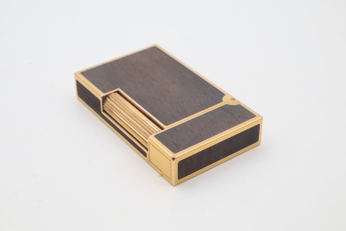 S.T. Dupont Ligne 2 gold plated lighter with dark wood inlay panels, marked MODELE on the base