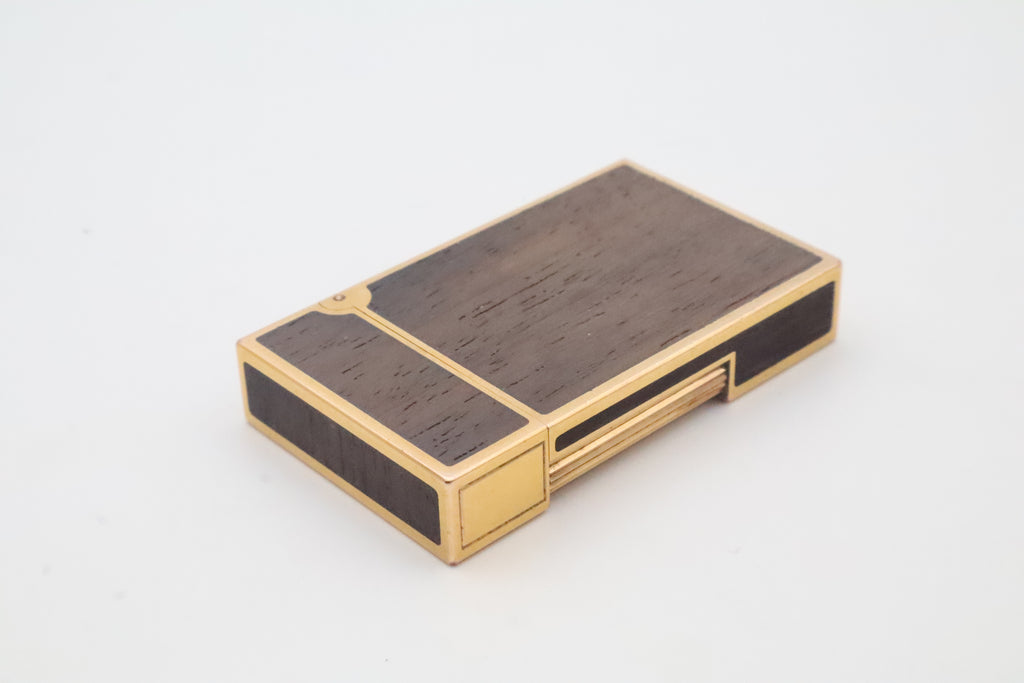 S.T. Dupont Ligne 2 gold plated lighter with dark wood inlay panels, marked MODELE on the base