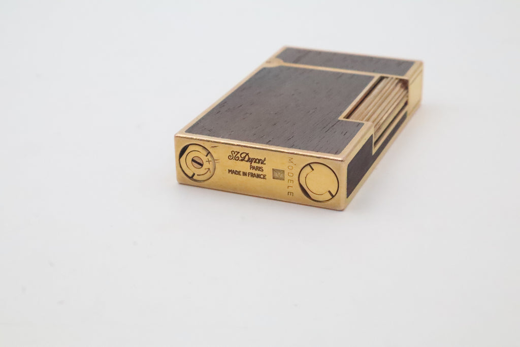 Base of the S.T. Dupont Ligne 2 wood inlay lighter, engraved S.T. Dupont Paris Made in France with the MODELE mark