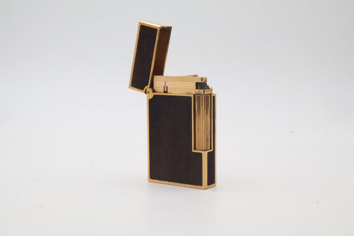 S.T. Dupont Ligne 2 gold plated lighter with dark wood inlay panels, marked MODELE on the base
