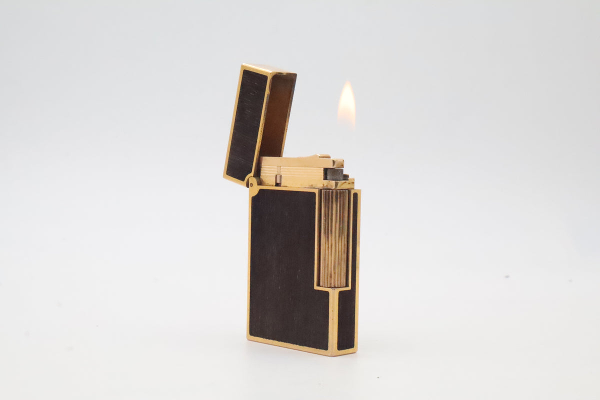 S.T. Dupont Ligne 2 gold plated lighter with dark wood inlay panels, marked MODELE on the base