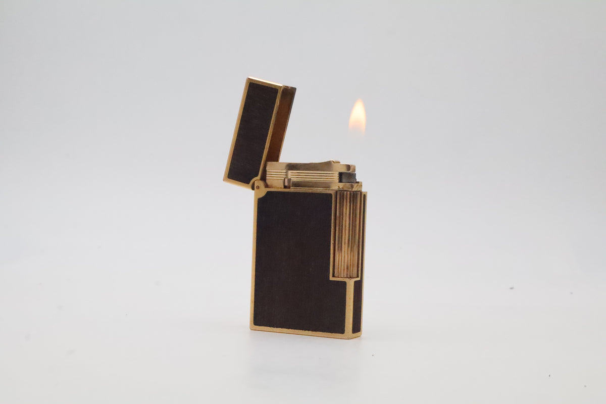 S.T. Dupont Ligne 2 gold plated lighter with dark wood inlay panels, marked MODELE on the base