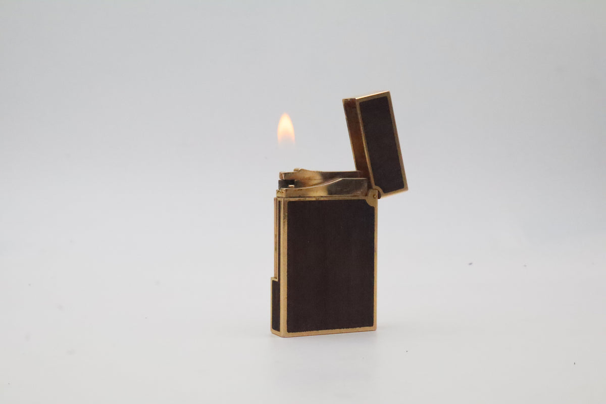 S.T. Dupont Ligne 2 gold plated lighter with dark wood inlay panels, marked MODELE on the base