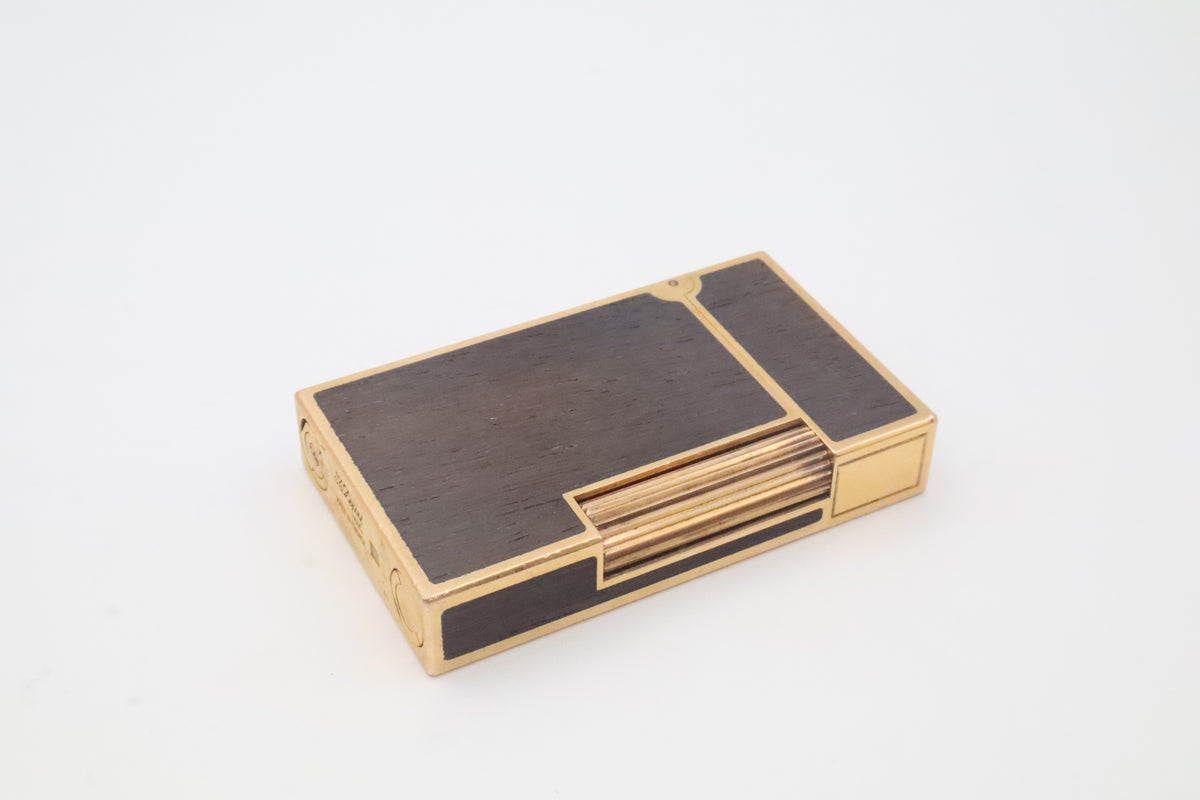 S.T. Dupont Ligne 2 gold plated lighter with dark wood inlay panels, marked MODELE on the base