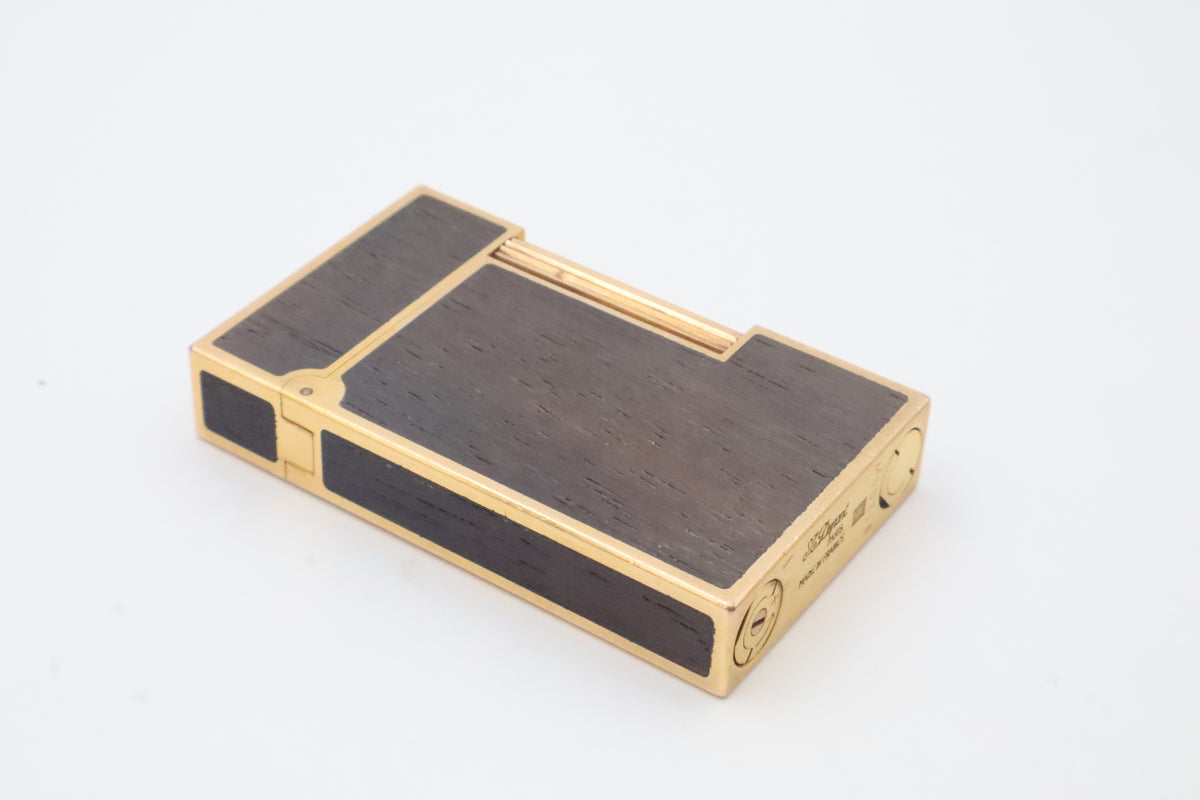 S.T. Dupont Ligne 2 gold plated lighter with dark wood inlay panels, marked MODELE on the base