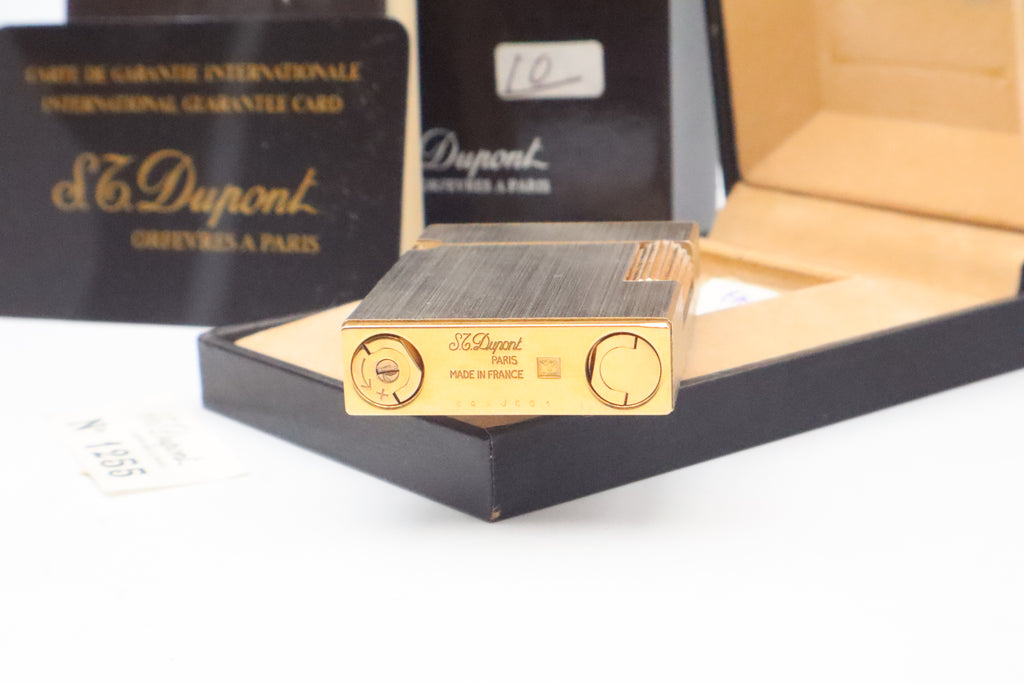 Base of the S.T. Dupont Ligne 2 reference 15401 lighter showing the serial 84 K JC 01, matching the box label